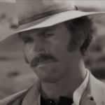 Primer plano de Franco Nero como Yodlaf Peterson en Vamos a matar, compañeros (1970).